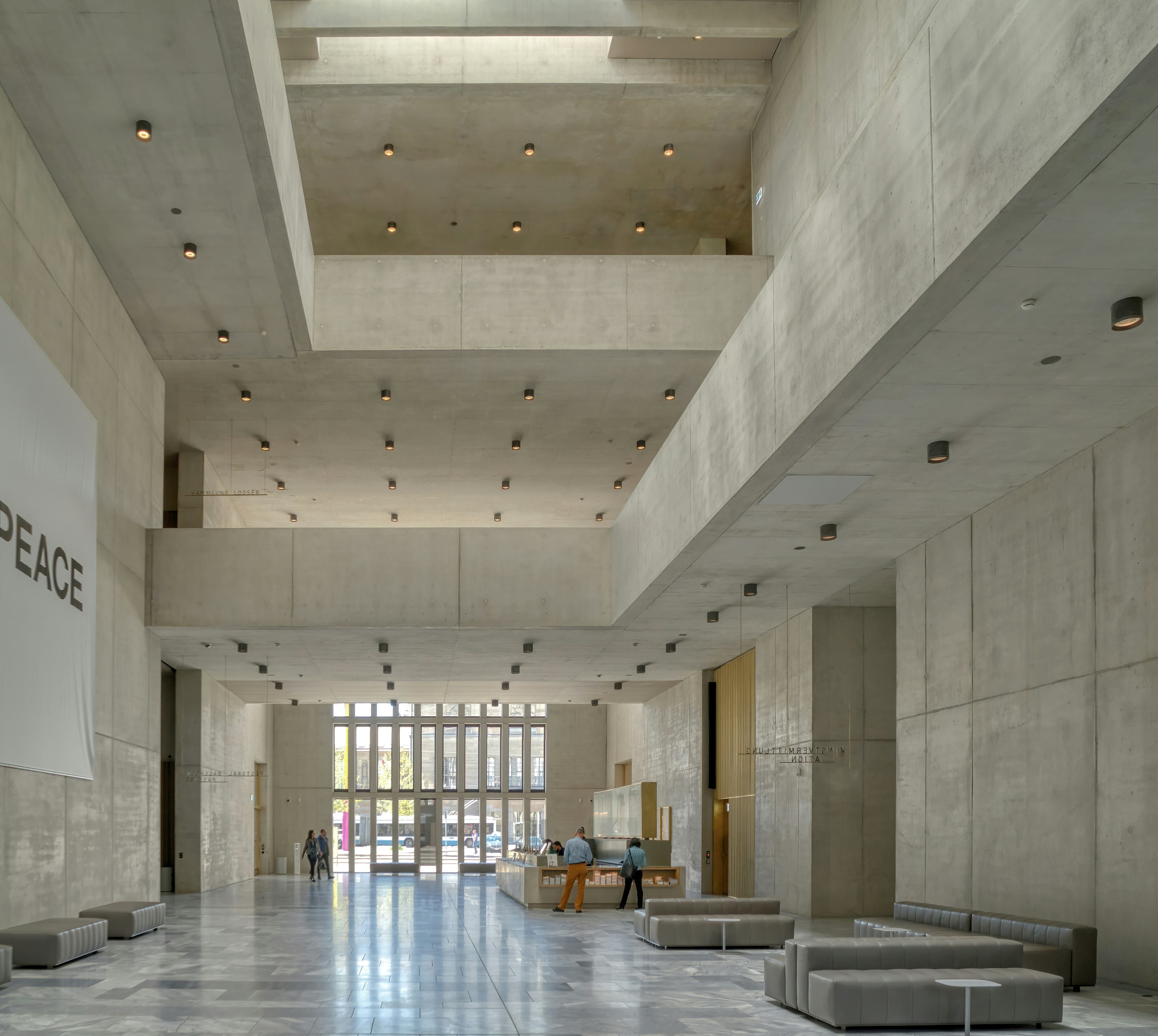 Concrete building lobby with a reception area